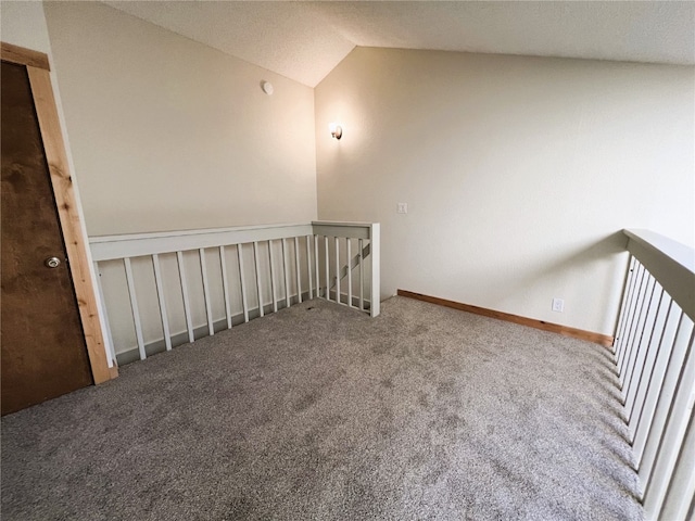 additional living space featuring vaulted ceiling, baseboards, and carpet floors