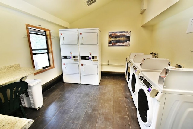 community laundry room with independent washer and dryer, stacked washer and dryer, baseboards, and visible vents