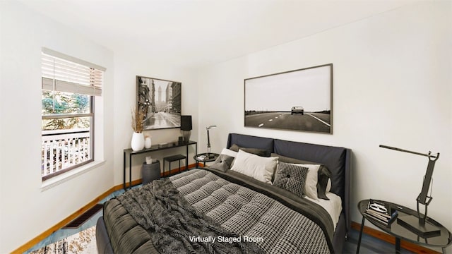 bedroom featuring wood finished floors and baseboards