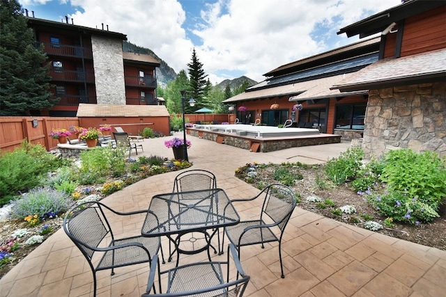 view of patio featuring outdoor dining area and fence