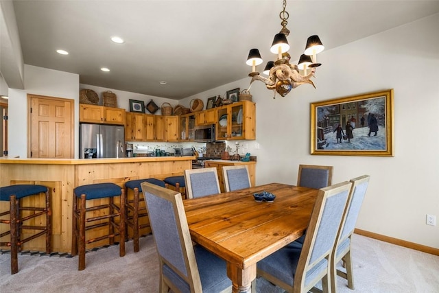 2838 Kitzbuhel Court ., Steamboat Springs, CO 80487 - dining area with recessed lighting, baseboards, light carpet, and an inviting chandelier