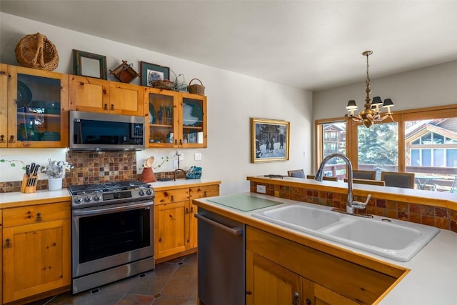 2838 Kitzbuhel Court ., Steamboat Springs, CO 80487 - kitchen with a sink, a chandelier, decorative backsplash, light countertops, and appliances with stainless steel finishes