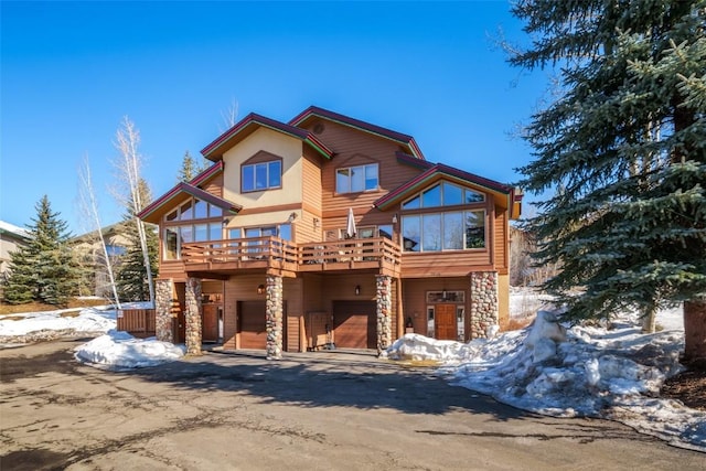 2838 Kitzbuhel Court ., Steamboat Springs, CO 80487 - view of front of home with stone siding, driveway, a carport, and a garage