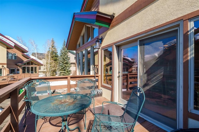 2838 Kitzbuhel Court ., Steamboat Springs, CO 80487 - view of wooden balcony with outdoor dining area and a deck