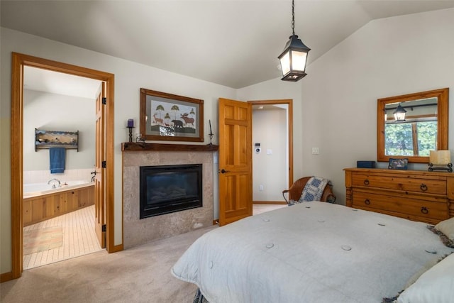 2838 Kitzbuhel Court ., Steamboat Springs, CO 80487 - bedroom with light carpet, a tiled fireplace, baseboards, vaulted ceiling, and connected bathroom