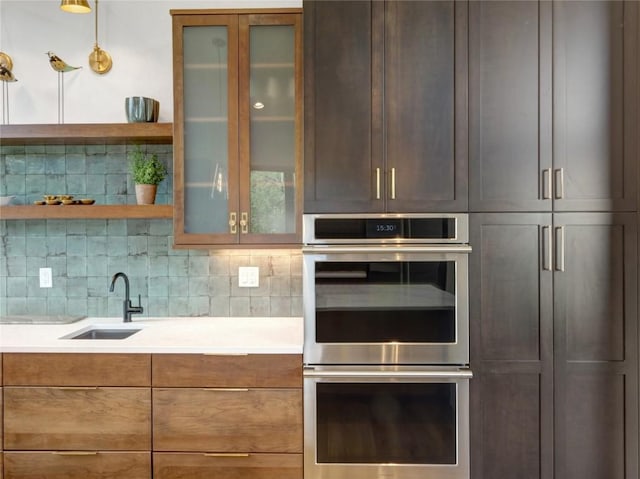 304 Raven Golf Ln, Silverthorne, CO 80498 - kitchen featuring stainless steel double oven, backsplash, light countertops, and glass insert cabinets