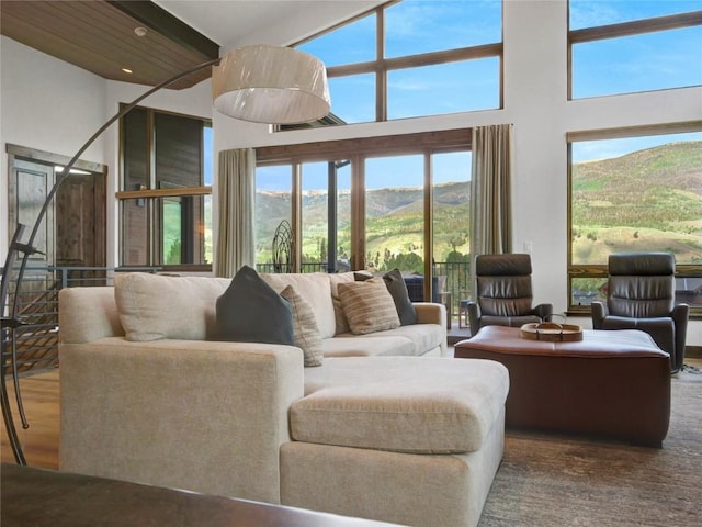 304 Raven Golf Ln, Silverthorne, CO 80498 - living room featuring a towering ceiling, healthy amount of natural light, a mountain view, and wood finished floors