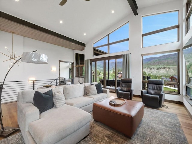 304 Raven Golf Ln, Silverthorne, CO 80498 - living room with beamed ceiling, wood finished floors, high vaulted ceiling, recessed lighting, and a chandelier