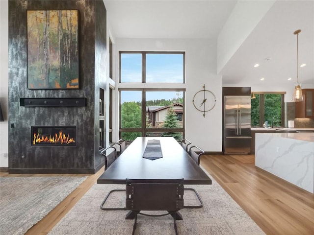 304 Raven Golf Ln, Silverthorne, CO 80498 - dining room featuring plenty of natural light, wood finished floors, and a fireplace