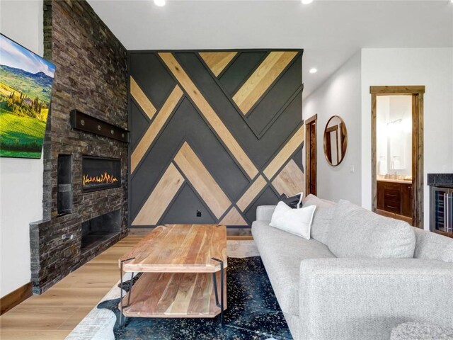 304 Raven Golf Ln, Silverthorne, CO 80498 - living area featuring a lit fireplace, wood finished floors, and recessed lighting