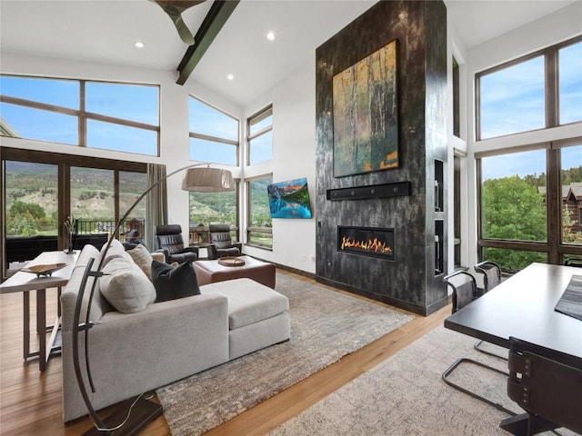 304 Raven Golf Ln, Silverthorne, CO 80498 - living room featuring high vaulted ceiling, beamed ceiling, a fireplace, wood finished floors, and recessed lighting