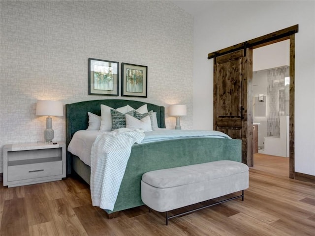 304 Raven Golf Ln, Silverthorne, CO 80498 - bedroom with wood finished floors and a barn door