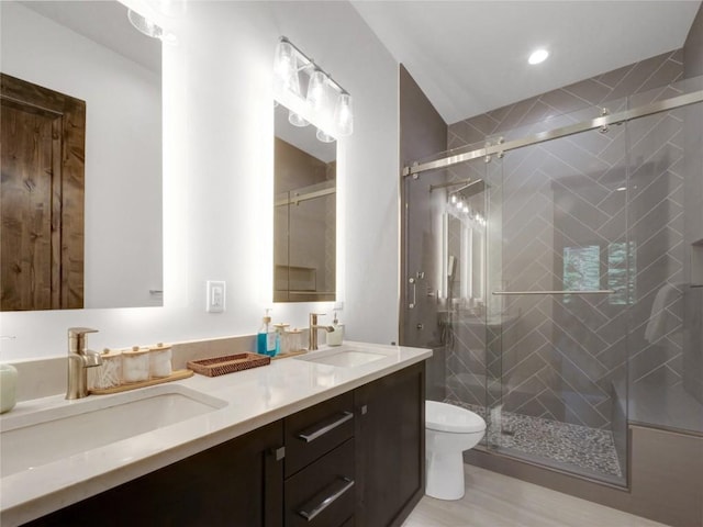 304 Raven Golf Ln, Silverthorne, CO 80498 - full bathroom featuring double vanity, a shower stall, wood finished floors, and recessed lighting