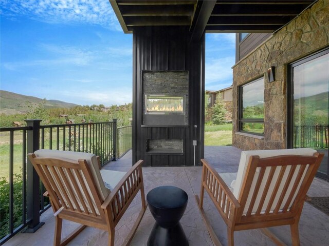 304 Raven Golf Ln, Silverthorne, CO 80498 - balcony featuring a fireplace and a mountain view