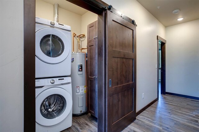 320 Fox Springs Cir Unit 302, Steamboat Springs, CO 80487 - laundry area with stacked washer / dryer, electric water heater, wood finished floors, baseboards, and recessed lighting