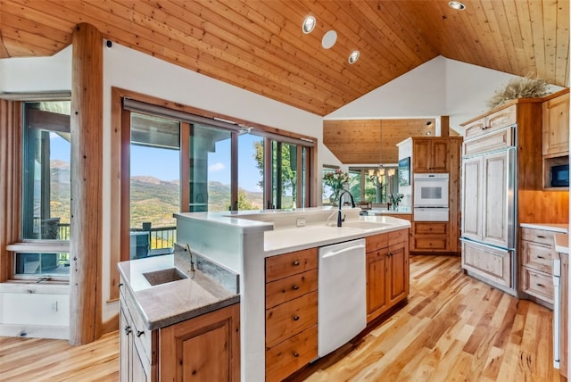 731 Lakeview Cir, Silverthorne, CO 80498 - kitchen featuring dishwasher, paneled built in fridge, a warming drawer, a sink, and a center island with sink