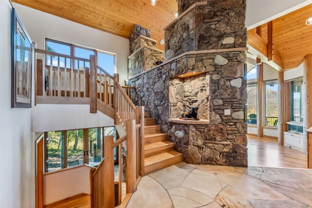 731 Lakeview Cir, Silverthorne, CO 80498 - stairway with wood ceiling, high vaulted ceiling, plenty of natural light, a fireplace, and french doors