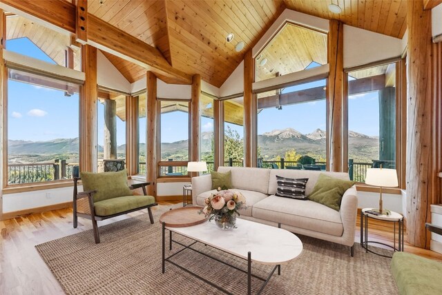 731 Lakeview Cir, Silverthorne, CO 80498 - sunroom featuring a mountain view, vaulted ceiling, wood finished floors, wooden ceiling, and baseboards