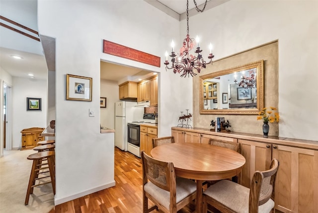 dining room with an inviting chandelier and light wood finished floors