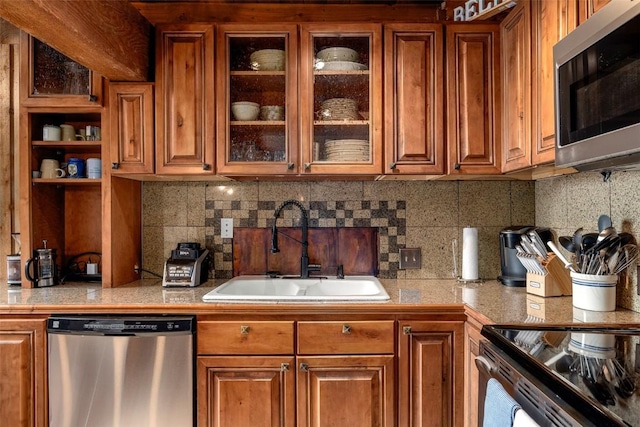 31500 Runaway Pl Unit 405, Steamboat Springs, CO 80487 - kitchen featuring appliances with stainless steel finishes, a sink, and brown cabinetry