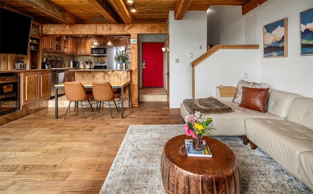 31500 Runaway Pl Unit 405, Steamboat Springs, CO 80487 - living room with beamed ceiling, light wood-style flooring, wooden ceiling, and beverage cooler