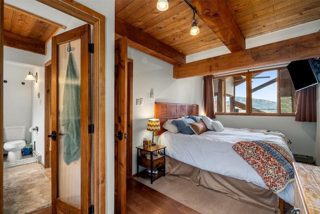 31500 Runaway Pl Unit 405, Steamboat Springs, CO 80487 - bedroom featuring wood ceiling, wood finished floors, beamed ceiling, and connected bathroom
