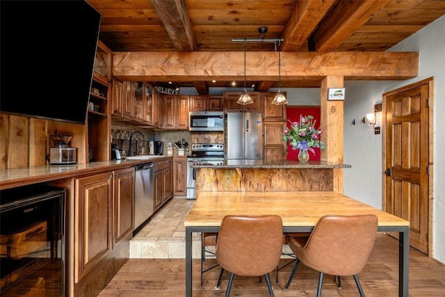 31500 Runaway Pl Unit 405, Steamboat Springs, CO 80487 - kitchen with appliances with stainless steel finishes, wood ceiling, beverage cooler, beam ceiling, and light wood-style flooring