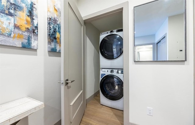 75 W 4th St Unit 206, Silverthorne, CO 80497 - laundry area with stacked washing machine and dryer, wood finished floors, and baseboards