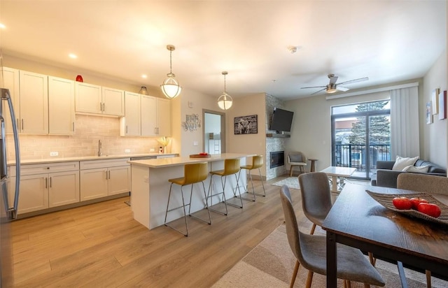 75 W 4th St Unit 206, Silverthorne, CO 80497 - kitchen featuring open floor plan, a sink, a center island, backsplash, and recessed lighting