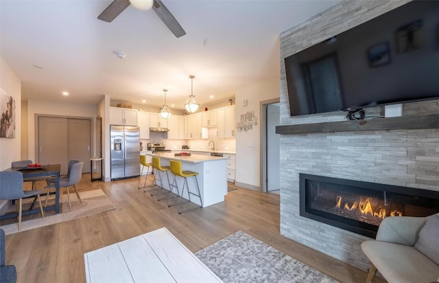 75 W 4th St Unit 206, Silverthorne, CO 80497 - living area featuring ceiling fan, light wood-style flooring, recessed lighting, and a fireplace