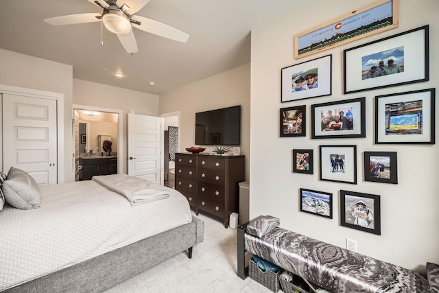 bedroom featuring ceiling fan and ensuite bath
