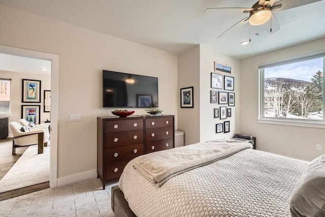 bedroom featuring baseboards and ceiling fan