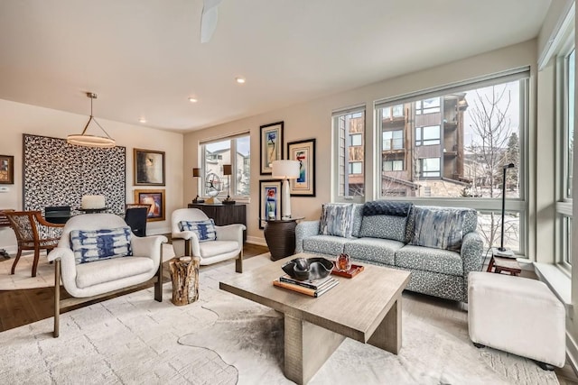 living area with plenty of natural light, baseboards, wood finished floors, and recessed lighting