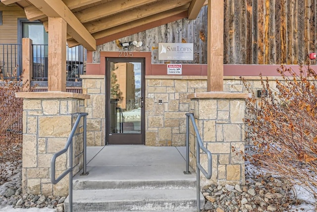 property entrance with stone siding