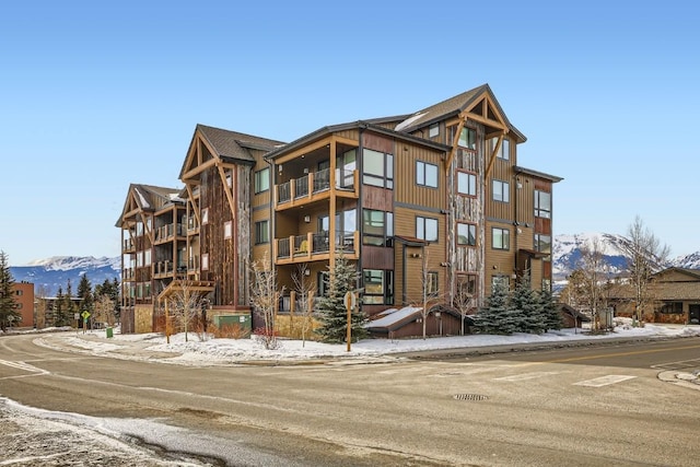 snow covered building featuring a mountain view