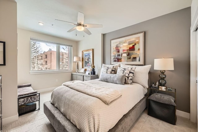 bedroom with baseboards and ceiling fan