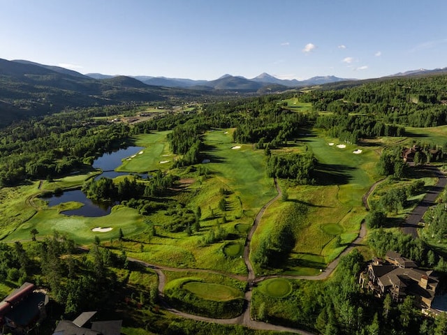 birds eye view of property with view of golf course and a water and mountain view