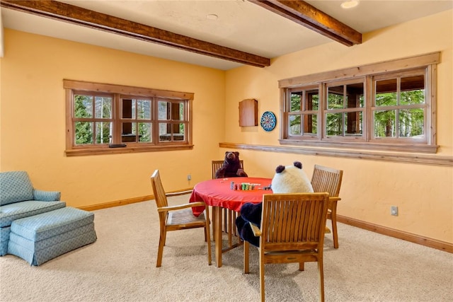 dining area with carpet, baseboards, and beamed ceiling