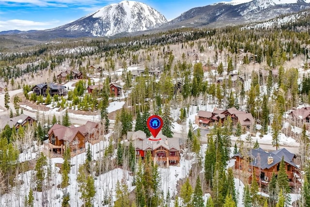 snowy aerial view with a residential view and a mountain view