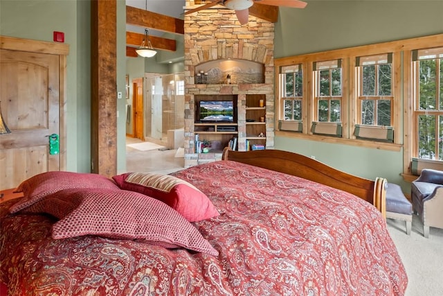bedroom with a stone fireplace and carpet