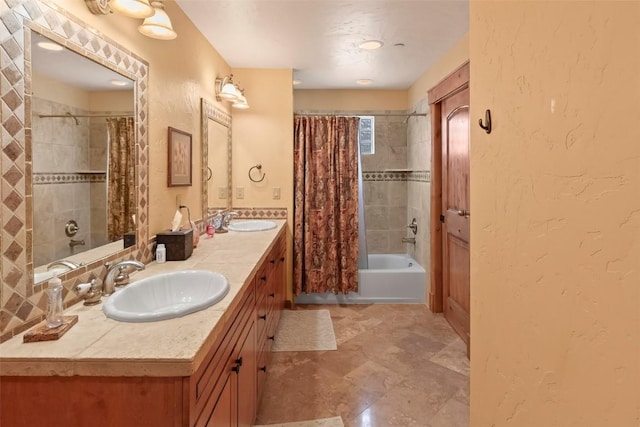 full bathroom with double vanity, a textured wall, shower / bathtub combination with curtain, and a sink