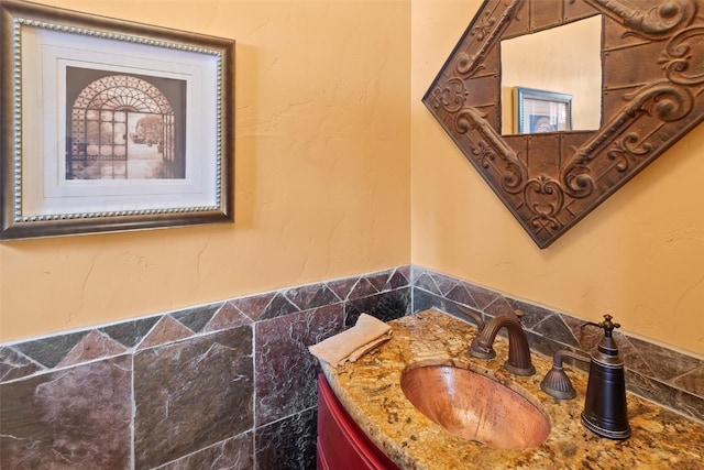 bathroom with tile walls and vanity
