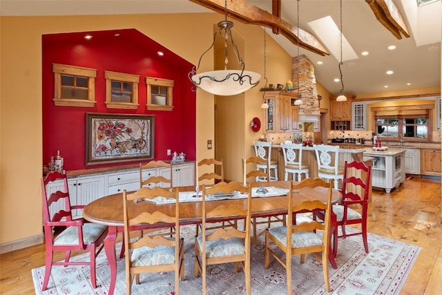 dining area with visible vents, a skylight, high vaulted ceiling, light wood-style floors, and recessed lighting
