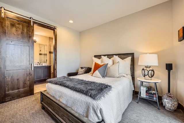 713 Fairways Dr Unit 1B, Breckenridge, CO 80424 - bedroom featuring light colored carpet, recessed lighting, ensuite bathroom, and a barn door