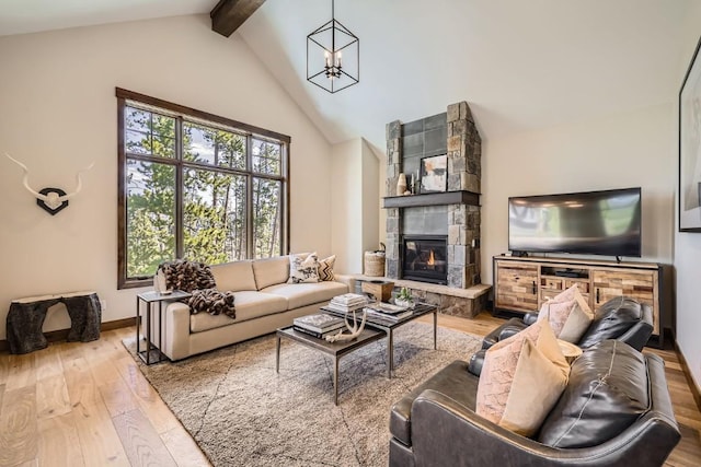 713 Fairways Dr Unit 1B, Breckenridge, CO 80424 - living area featuring beamed ceiling, hardwood / wood-style flooring, a fireplace, a chandelier, and baseboards