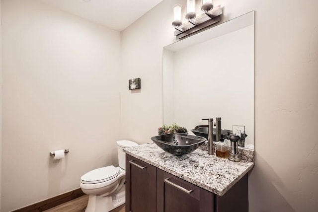 713 Fairways Dr Unit 1B, Breckenridge, CO 80424 - bathroom with toilet, vanity, wood finished floors, and baseboards