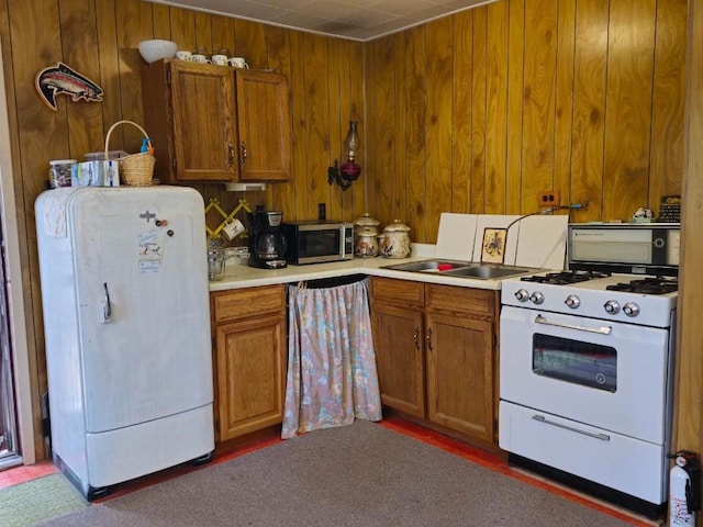 64 Ski Doo Ln, Fairplay, CO 80440 - kitchen with white appliances, light countertops, brown cabinets, and wooden walls