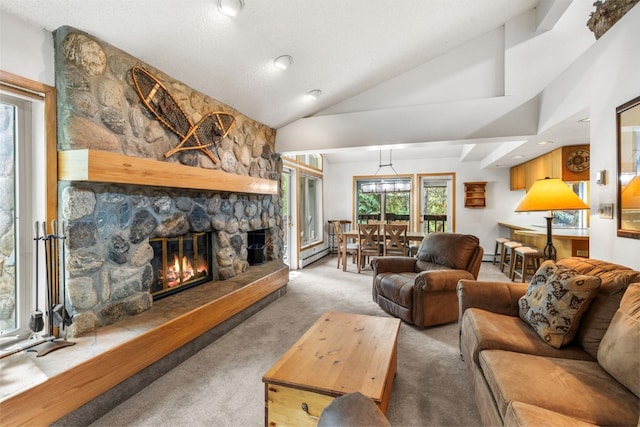 203 Creekside Dr Unit 201, Frisco, CO 80443 - carpeted living area with a fireplace, lofted ceiling, baseboard heating, and a baseboard heating unit