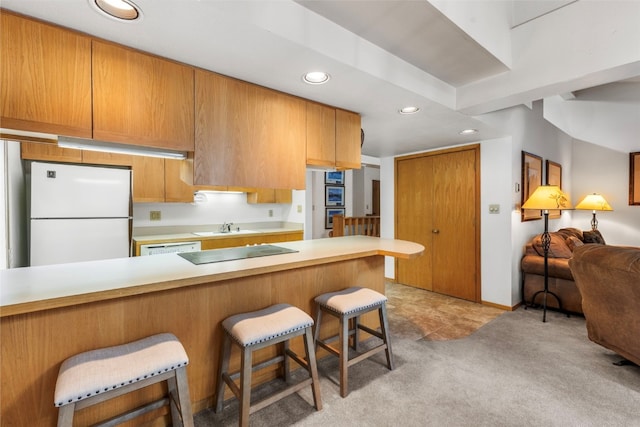 203 Creekside Dr Unit 201, Frisco, CO 80443 - kitchen with white appliances, recessed lighting, a breakfast bar, light countertops, and light carpet