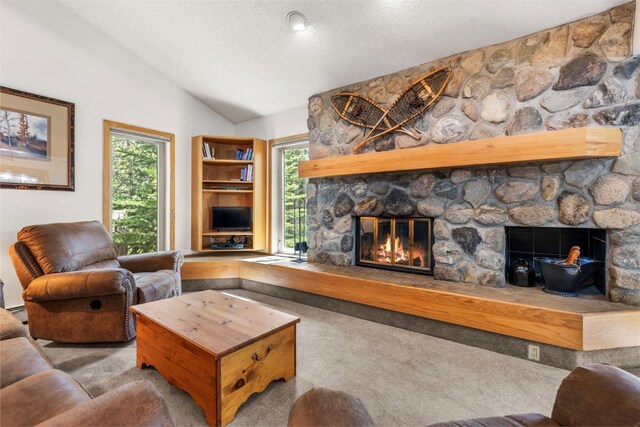 203 Creekside Dr Unit 201, Frisco, CO 80443 - carpeted living area featuring a fireplace, a textured ceiling, and lofted ceiling
